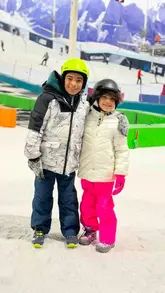 A family-focused vlog showcasing a visit to an indoor snow centre in Manchester, highlighting activities like tubing, sledging, and playing in the snow.