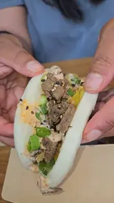 A handheld review of Grounded Kitchen at Fosse Park, showcasing the ordering process, interior, and a variety of their rice bowls, bao buns, udon noodles, and drinks.