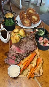 A couple visits The Old Mill in Ashford to review their Sunday roast and seafood tower. The video features close-ups of the food, the venue's interior, and the creators' reactions to the meal.
