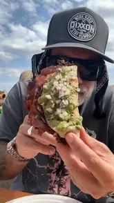 The creator visits 'The Tacover' food festival, sampling a variety of unique tacos from different vendors including Pretty Boy Tacos, Slam BBQ, Death By Tacos, Chicken George, Taco Dave, and Hungry Taco. The video captures the festival atmosphere and provides quick, enthusiastic reviews of each dish.