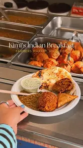 A creator visits Kimi's Indian Catering, a long-standing food stall at the Riverside Farmers' Market in Cardiff, to review their affordable and authentic Indian breakfast.