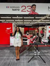 A photo of a creator standing in a Formula E pit lane garage, showcasing the behind-the-scenes experience of a race weekend.