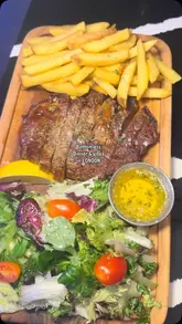 A montage video showcasing a bottomless dinner experience at a venue in Tooting, London, featuring various dishes like steak, burgers, and prawns, alongside cocktails and the venue's interior.