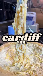 A creator visits Cardiff Market to sample street food from 'The Bearded Taco' and 'Dirty Gnocchi', showcasing the preparation and taste of tacos and bacon carbonara.
