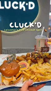 A promotional video for a new grilled chicken restaurant in Leicester, featuring shots of the interior, self-service kiosks, and various menu items like burgers, wings, and fries.