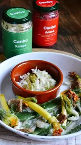 The creator reviews two varieties of Canbo sauerkraut, Xalapa and Adana, describing their ingredients, flavor profiles, and serving suggestions. The video features the creator talking to the camera, showing the jars, and tasting the product.