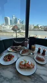 A promotional reel featuring a visit to the new Coppa Club location in London, highlighting the breakfast menu, stylish interiors, and the outdoor terrace with views of Tower Bridge.
