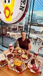 A couple visits Dave's Hot Chicken in Bristol to review their menu, including a spicy food challenge with the 'Reaper' level chicken.