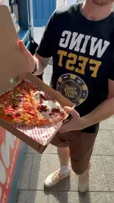 A creator visits Ernie's Pizza in Bristol, interviewing the owner and showcasing their New York-style pizza slices.