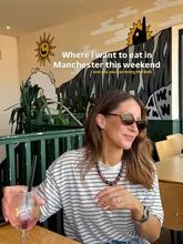 A bright, lifestyle-focused shot featuring a woman enjoying an Aperol Spritz in a venue with a colourful mural background. The image serves as an engaging introduction to a listicle about family-friendly dining spots in Manchester.