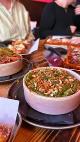 A vlog-style video showcasing a food tour at Princesshay in Exeter, visiting Yo! Sushi for conveyor belt sushi, Pop Kitchen for Detroit-style pizza and sides, and Chandos Deli for sweet treats.