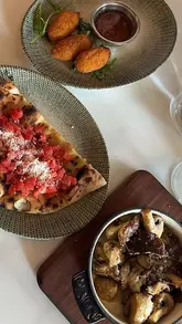 A montage video showcasing the interior and lunch menu at Aurelia in Aylesbury, featuring cocktails, various Italian dishes including pizza, pasta, and tiramisu.