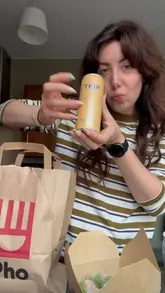 A creator reviews a delivery meal from Pho restaurant, featuring a collaboration with Trip drinks, specifically highlighting the 'Double Mango' deal including a mango salad, prawn summer rolls, and a mango-flavored CBD drink.