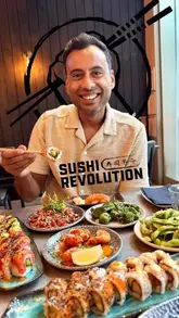 A couple visits Sushi Revolution, showcasing the interior, the open kitchen, and various sushi dishes.