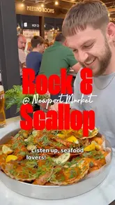 A high-energy vlog featuring two creators reviewing a seafood boil at Rock & Scallop in Newport Market. The video highlights the generous portion sizes, the 'VIP' and 'Classic' lunch deals, and the messy, hands-on experience of eating the meal.