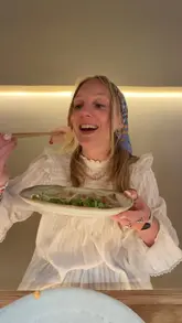 A vlog-style review of a handroll bar in Mayfair, featuring the creator and a friend trying various sushi dishes, including temaki, sashimi, and wagyu sliders.