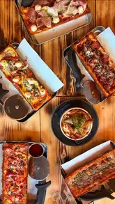 A vlog-style video following a creator's evening at Princesshay, Exeter, visiting Yo Sushi for conveyor belt sushi, Pop Kitchen for Detroit-style pizza and mac and cheese, and Chandos Deli for dessert treats.