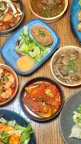A vlog-style video showcasing an all-you-can-eat Mediterranean restaurant experience, featuring the ordering process via tablet, a salad bar, various small plates, cocktails, and unlimited dessert.