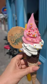 A montage of soft-serve ice cream cones with various toppings, including lemon and strawberry flavours, held by the creator.