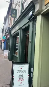 A tour of an Irish pub in Worcester, showcasing the interior decor, memorabilia, and the pouring of a pint of Guinness.