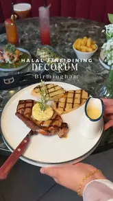 A promotional video for Decorum in Birmingham, showcasing their interior, cocktails, and various dishes including steak, ribs, and bao buns.