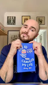A creator demonstrates his preferred burger recipe while promoting his food memoir, 'How an Egg Changed My Life,' sharing personal anecdotes about his youth.