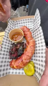 A couple visits a BBQ festival in Manchester, sampling various grilled dishes including burgers, prawns, oysters, and sausages. The video captures the lively atmosphere of the event and provides quick, enthusiastic reactions to the food.