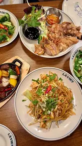 A vibrant and engaging review of La Viet in Edinburgh, showcasing the restaurant's cosy interior and a variety of authentic Vietnamese dishes including spring rolls, shaking beef, and crispy roast duck.
