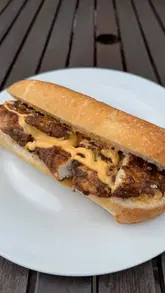 A home cooking tutorial demonstrating how to make a buttermilk jerk fried chicken sub using a specific spice blend. The video covers the marinating, coating, and frying process.