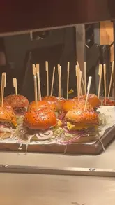 A high-energy montage capturing the launch party of The Beefy Boys in Exeter, featuring shots of the venue, the burger menu, and the lively atmosphere with entertainment.