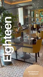 A video showcasing a visit to Eighteen restaurant in Christchurch, featuring shots of the interior, menu, various dishes like steak and lamb, cocktails, and a live jazz singer.