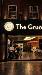 A promotional reel for The Grumpy Baker in Manchester, featuring close-up shots of various cheesecakes, indulgent desserts, and specialty drinks like matcha and iced coffee, set within their new venue.