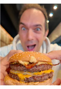 Enjoying the best burger in London at Bleecker Burger during a fun London adventure.