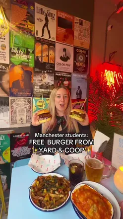 Students enjoying free chicken burgers at Yard & Coop in Manchester on October 1st with valid ID.