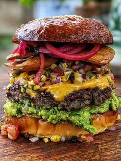 Delicious burger topped with Mexican spicy cheese, showcasing gourmet flavors and vibrant plating. #Burger #Mexico