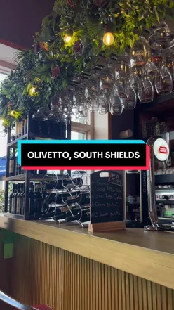 Couple enjoying tender meat and crunchy vegetables at Olivetto in South Shields for Sunday dinner, starting at £11.95.