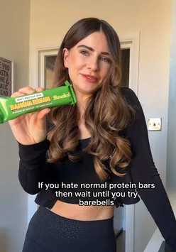 Delicious Barebells protein bars displayed with gym gear, perfect for fitness enthusiasts in London.