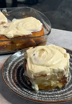 Delicious, fluffy homemade cinnamon rolls with cream cheese icing and warm spices, perfect for autumn treats.