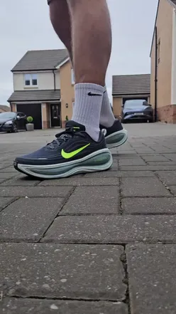 Person wearing Nike Vonero Plus Hoodie and Montirex Dublin Vest, enjoying a run in athletic shorts, promoting fitness lifestyle.