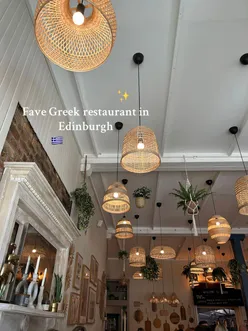 Diners enjoying Greek cuisine at Fava, a top restaurant in Edinburgh with a warm atmosphere.
