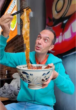 Enjoying Belt Noodles at Destination Fun in London, showcasing unique food experiences.