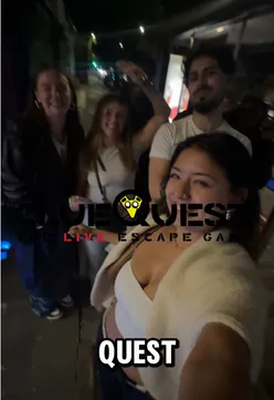 Team celebrating after escaping an escape room at clueQuest in London, with drinks in hand and smiles all around.