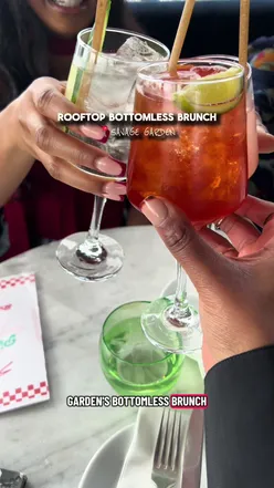 Enjoying a bottomless brunch for £50 at a rooftop venue in London with cocktails and delicious food.