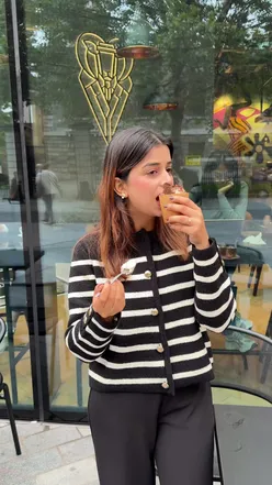 Enjoying eco-friendly Cookie Cloud Cups at Ovis Coffee, featuring pistachio, tiramisu, and ube flavors.