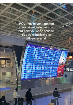 Influencer posing at Paris Charles de Gaulle Airport with travel vibes and departures board in the background.