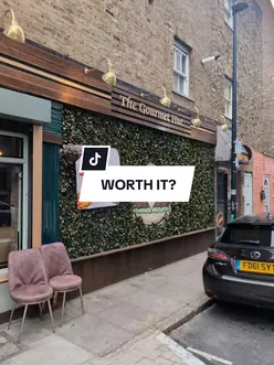 People enjoying dishes at The Gourmet Hut in Whitechapel, London, known for its delicious halal food.