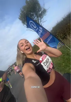 'Runner celebrating after completing a 10-mile run in York, showing determination and joy in a scenic outdoor setting.'