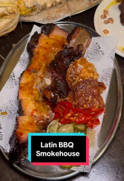 'Delicious smoked meats at Latin BBQ Smokehouse in The Hawke Pub, London, featuring tacos, pork belly, and turkey burger.'