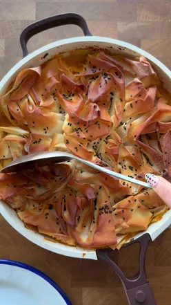 COCONUT CHICKEN CURRY PIE It just slaps. That is the description. Serves 4. ▫️ 1 small white onion ▫️ 3 garlic cloves ▫️ 1 inch ginger ▫️ 1/2 tsp fennel seeds ▫️ 1 tbsp tomato paste  ▫️ 1 tsp ground cumin ▫️ 1 tsp ground coriander ▫️ 1/2 tsp turmeric ▫️ 2 large chicken breasts, diced ▫️ 1 x 400g tin chickpeas ▫️ juice of 1/2 lemon ▫️ 1 x 400ml tin coconut milk ▫️ handful of spinach ▫️ 6 sheets filo pastry ▫️ mint yoghurt, to serve ▫️ mango chutney, to serve Method: 1. Preheat the oven to 200°C. 2. Heat a glug of oil in a deep, ovenproof frying pan over a medium heat. Add the onion with a pinch of salt and cook for about 5 minutes until softened. 3. Stir in the garlic and ginger and cook for a minute, then add the fennel seeds, tomato paste, cumin, coriander and turmeric. Cook for another minute until fragrant and everything is nicely coated. 4. Add the chicken and cook for 3–4 minutes to seal, then tip in the chickpeas and lemon juice. Pour in the coconut milk, season well and let it gently simmer for 5 minutes. 5. Add the spinach a handful at a time until just wilted, then take the pan off the heat. 6. Scrunch the filo sheets loosely and arrange them over the curry. Brush generously with oil and sprinkle with seeds if you like. 7. Bake for 10 minutes, until the filo is golden and crisp and the chicken is cooked through. Serve with mint yoghurt and mango chutney. ENJOY! #filopie #chickencurry #foodtok 