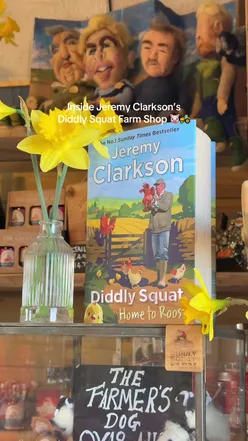 Visitor enjoying a bacon roll at Diddly Squat Farm Shop, Clarkson's Farm, Chipping Norton, UK.